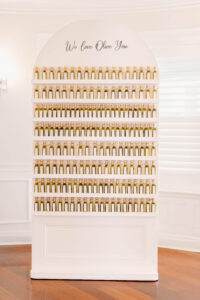 Wedding Photographers Newport RI | Deirdre Photography Timeless and Organic Moments | A white display shelf filled with small olive oil bottles arranged in rows. Above is the text "We Love Olive You."