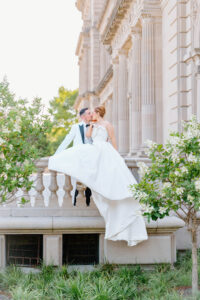 Bride and groom embracing on the steps of a historic estate with sweeping architecture and editorial-style composition captured by a Rhode Island wedding photographer.