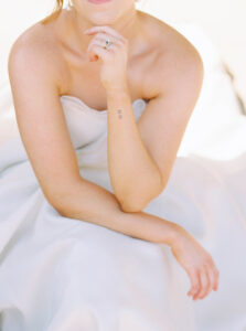 A soft, close-up portrait of a bride seated in natural light emphasizes texture and simplicity, aligning with the editorial style often seen across wedding venues Newport Rhode Island couples choose.